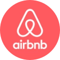 Airbnb logo icon in a red circle.